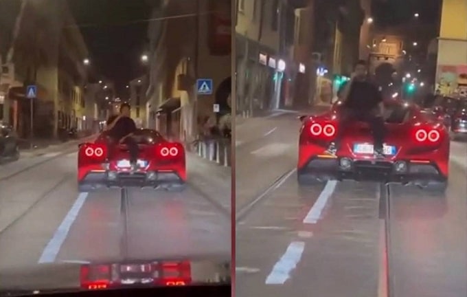 Seduto sul cofano di una Ferrari a parlare al telefono mentre l’auto gira per il centro di Milano [VIDEO]